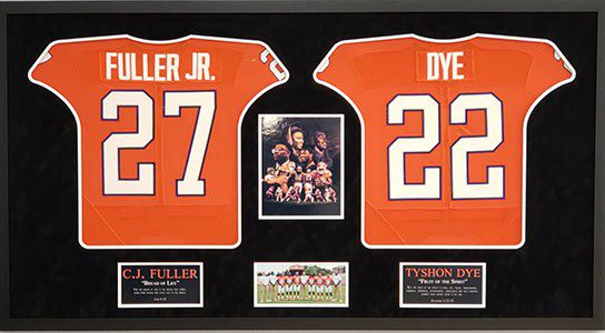 Framed jerseys and photos of football players.