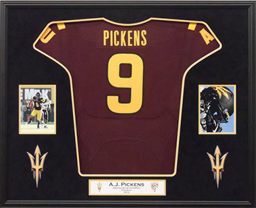 Framed maroon sports jersey with photos.