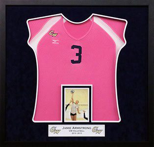 Pink volleyball jersey in framed display case.
