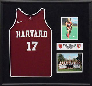 Harvard jersey with photos and plaque displayed.