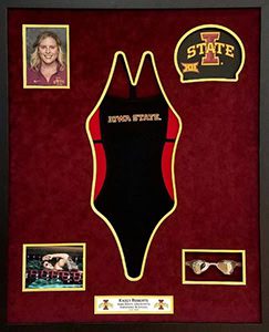 Framed Iowa State swimsuit and memorabilia display.