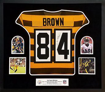 Framed football jersey with player photos.